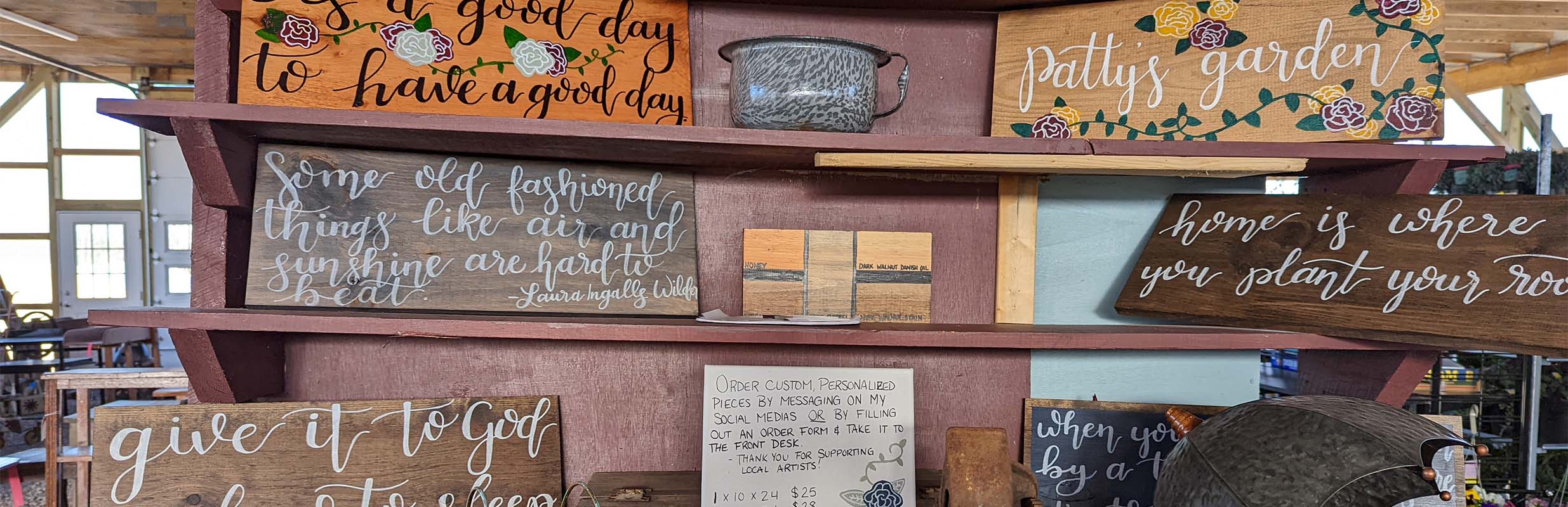 A shelf of antique wooden signs